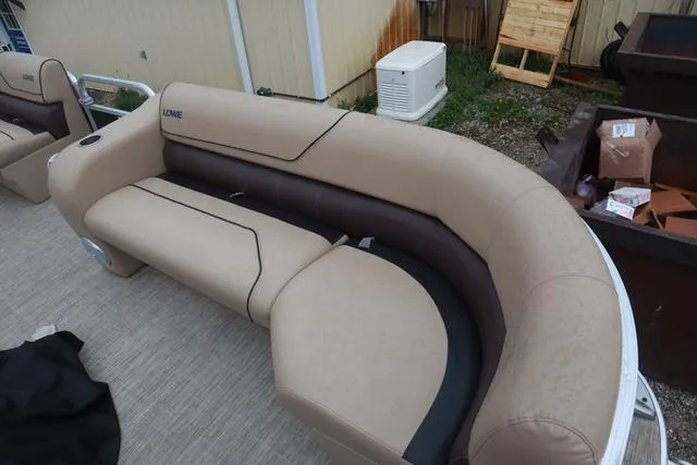 Slide: The Image of 2017 Lowe SF 232 boat seating with beige and brown upholstery, outdoor setting. - 5