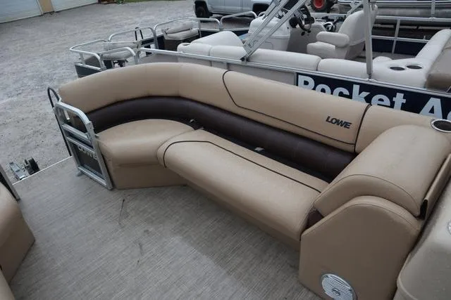 Slide: The Image of 2017 Lowe SF 232 pontoon boat with beige seating and spacious layout. - 6