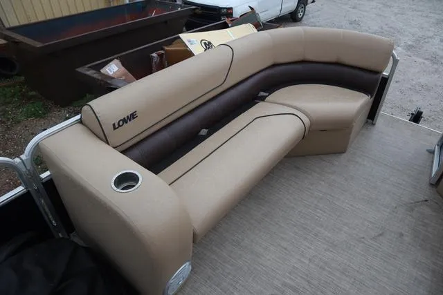 Slide: The Image of 2017 Lowe SF 232 pontoon boat with beige seating and cup holder. - 7
