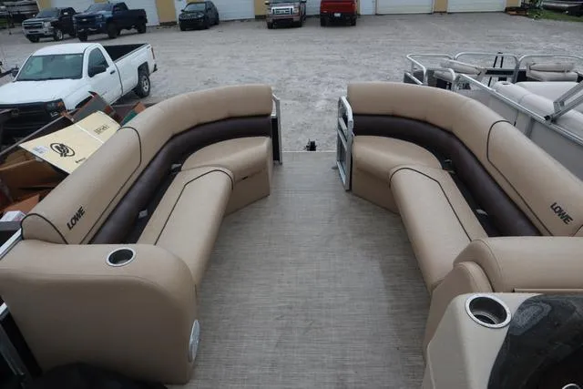 Slide: The Image of 2017 Lowe SF 232 pontoon boat with beige seating and cup holders. - 8