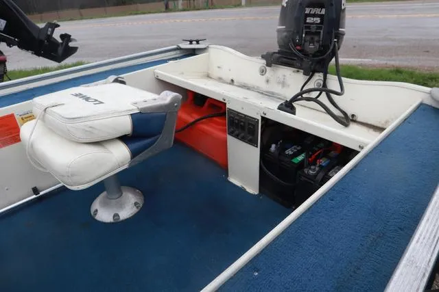 Slide: The Image of 1999 Lowe Sea Nymph 160 BT boat interior with seat, motor, and battery compartment. - 10