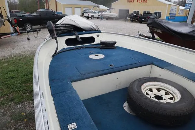 Slide: The Image of 1999 Lowe Sea Nymph 160 BT boat with blue interior and spare tire on deck. - 13