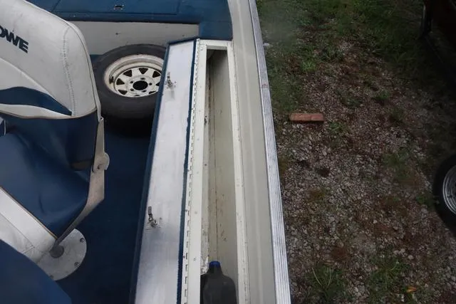 Slide: The Image of 1999 Lowe Sea Nymph 160 BT boat interior with storage compartment and seating. - 15