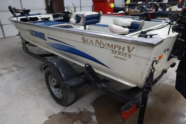 Slide: The Image of 1999 Lowe Sea Nymph 160 BT boat on trailer in garage setting. - 3