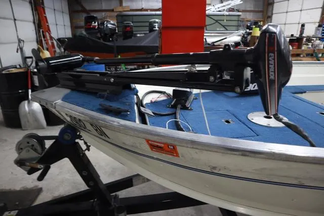 Slide: The Image of 1999 Lowe Sea Nymph 160 BT boat with Evinrude motor in a garage setting. - 4
