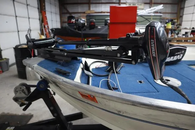 Slide: The Image of 1999 Lowe Sea Nymph 160 BT boat with Evinrude motor in a garage setting. - 5