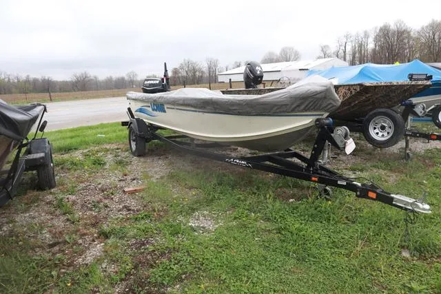 Slide: The Image of 1999 Lowe Sea Nymph 160 BT boat on trailer, covered, parked outdoors. - 7