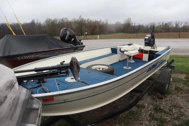 Slide: The Image of 1999 Lowe Sea Nymph 160 BT boat on trailer, parked outdoors. - 8