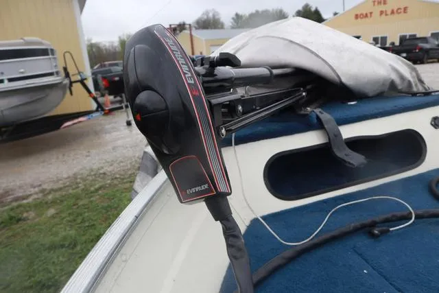 Slide: The Image of 1999 Lowe Sea Nymph 160 BT boat with Evinrude motor, parked at a boat dealership. - 9