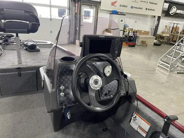 Slide: The Image of 2020 Tracker BASS TRACKER® Classic XL boat dashboard with steering wheel and navigation system. - 20