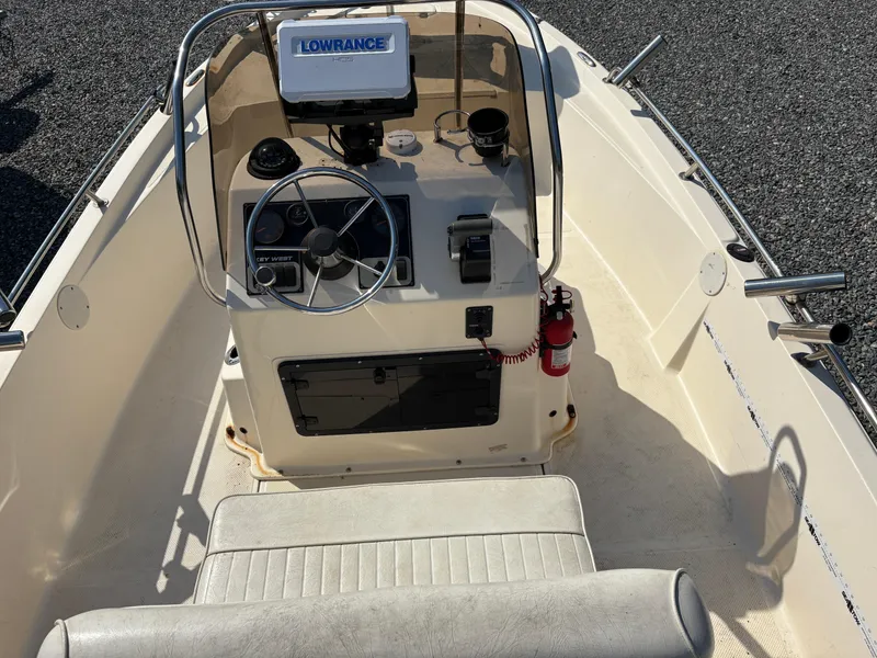 Slide: The Image of 2004 Key West 186 Bay Reef boat cockpit with steering wheel and Lowrance navigation system. - 12