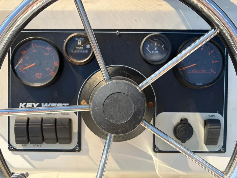 Slide: The Image of Steering wheel and dashboard of 2004 Key West 186 Bay Reef boat. - 14