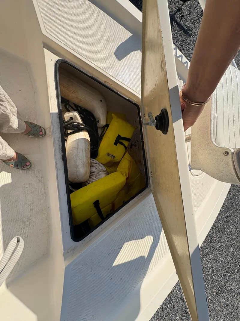 Slide: The Image of Open storage compartment on 2004 Key West 186 Bay Reef boat with life jackets and fenders. - 18