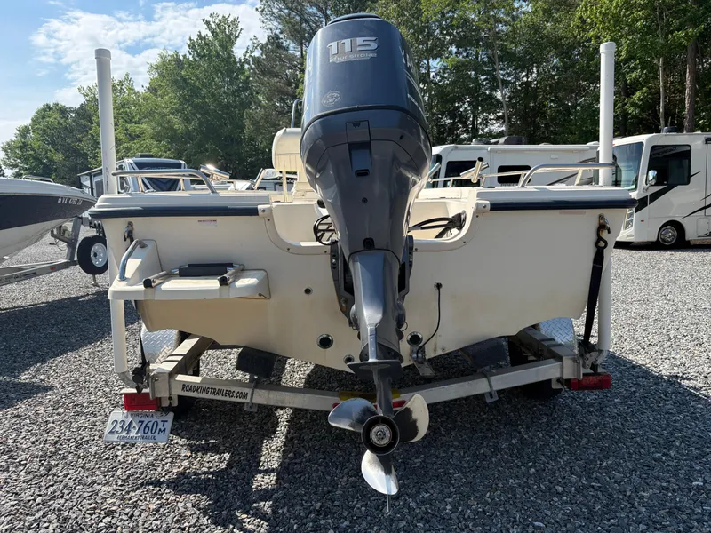 Slide: The Image of 2004 Key West 186 Bay Reef boat on trailer, featuring a 115 horsepower outboard motor. - 4