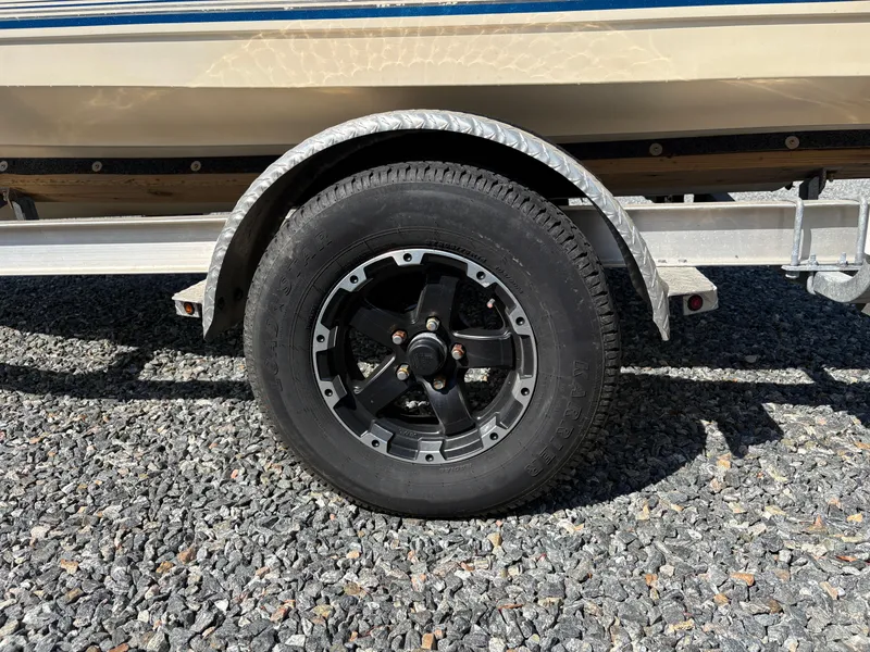 Slide: The Image of Trailer wheel of 2004 Key West 186 Bay Reef boat on gravel surface. - 9