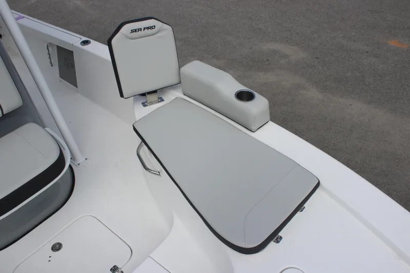 Slide: The Image of 2025 Sea Pro 230 Bay boat seating area with cushioned seat and cup holder. - 16