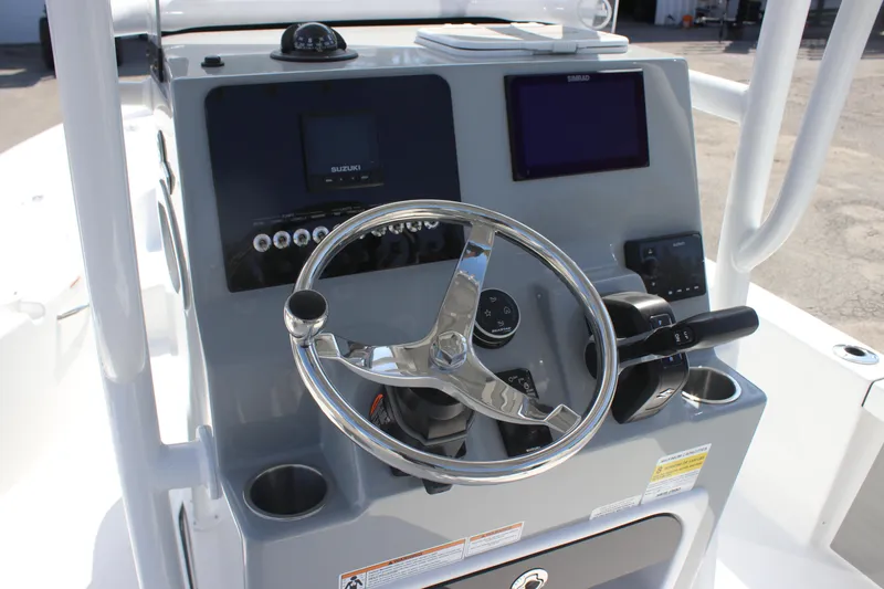 Slide: The Image of 2025 Sea Pro 230 Bay boat console with steering wheel and navigation displays. - 17