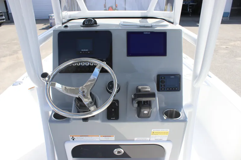 Slide: The Image of 2025 Sea Pro 230 Bay boat console with steering wheel and navigation screens. - 18