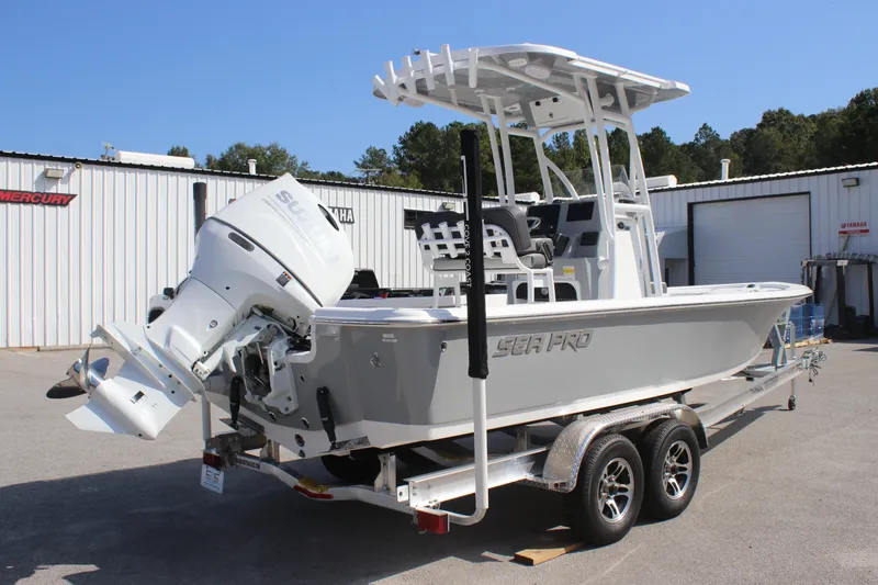 Slide: The Image of 2025 Sea Pro 230 Bay boat on trailer, featuring a powerful outboard motor. - 2