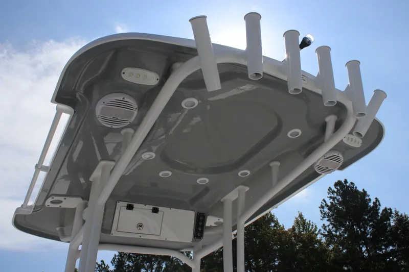 Slide: The Image of 2025 Sea Pro 230 Bay boat T-top with rod holders and speakers, viewed from below. - 20