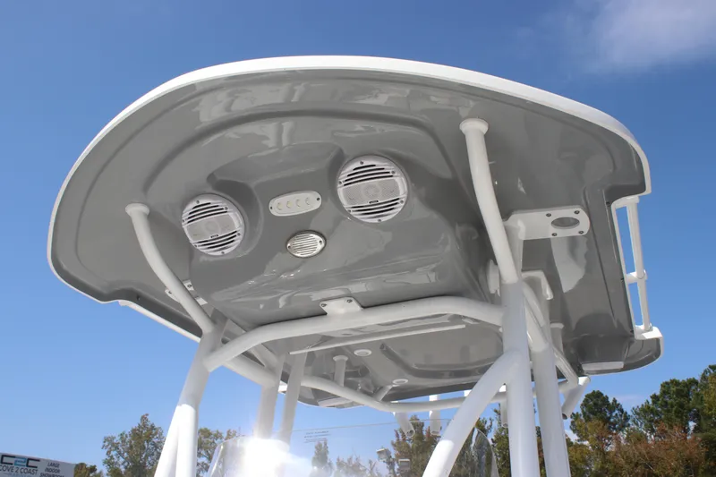 Slide: The Image of 2025 Sea Pro 230 Bay boat T-top with speakers against a clear blue sky. - 21