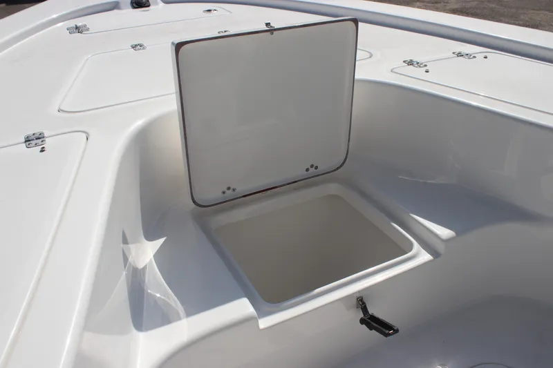 Slide: The Image of 2025 Sea Pro 230 Bay boat storage compartment, open lid, white interior. - 23