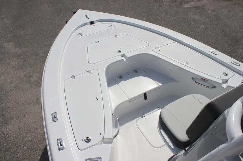Slide: The Image of 2025 Sea Pro 230 Bay boat deck with storage compartments and seating. - 27