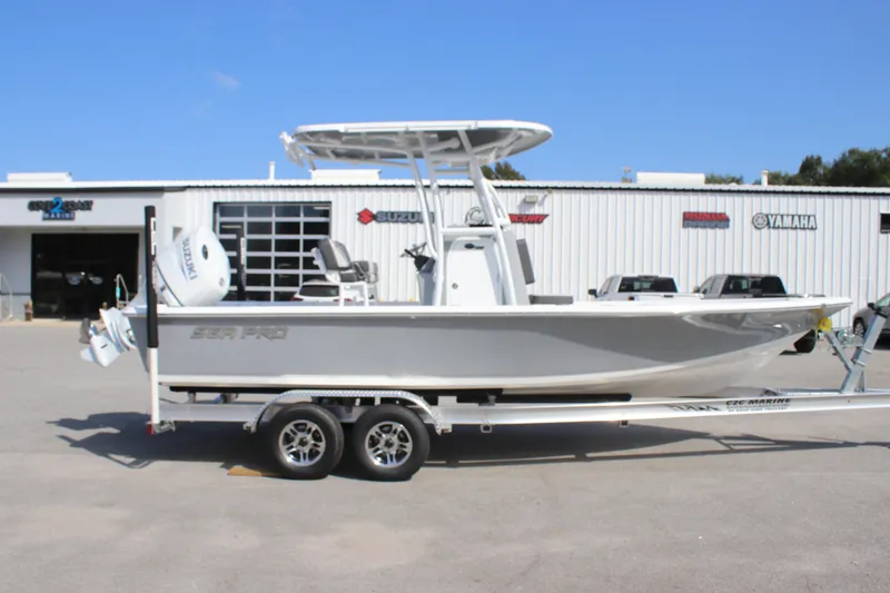 Slide: The Image of 2025 Sea Pro 230 Bay boat on trailer, parked outside dealership. - 3