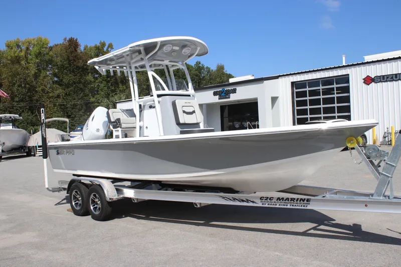 Slide: The Image of 2025 Sea Pro 230 Bay boat on trailer outside marine dealership. - 6