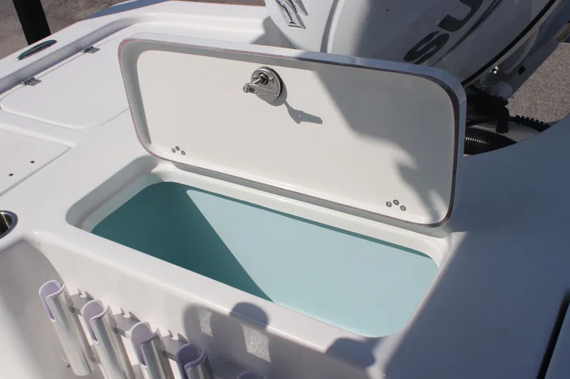 Slide: The Image of 2025 Sea Pro 230 Bay boat with open storage compartment and motor detail. - 9