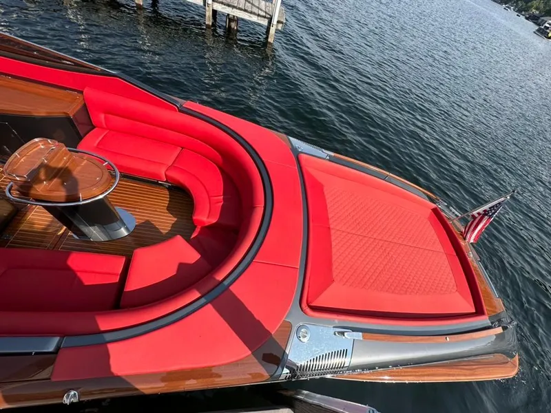 Slide: The Image of Luxurious 2013 Riva Aquariva 33 boat with vibrant red seating and elegant wood finish. - 11