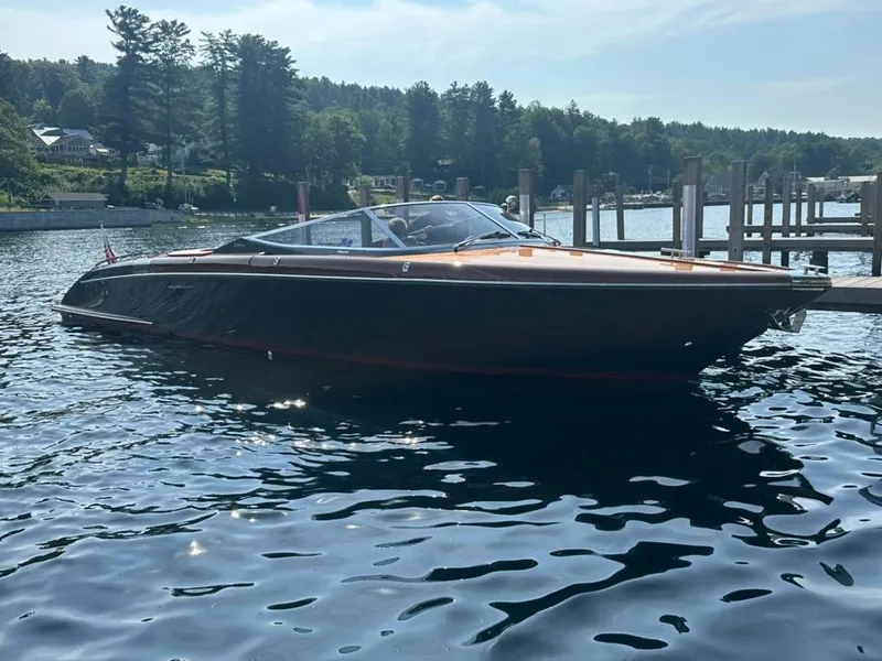 Slide: The Image of 2013 Riva Aquariva 33 boat docked on a serene lake. - 15