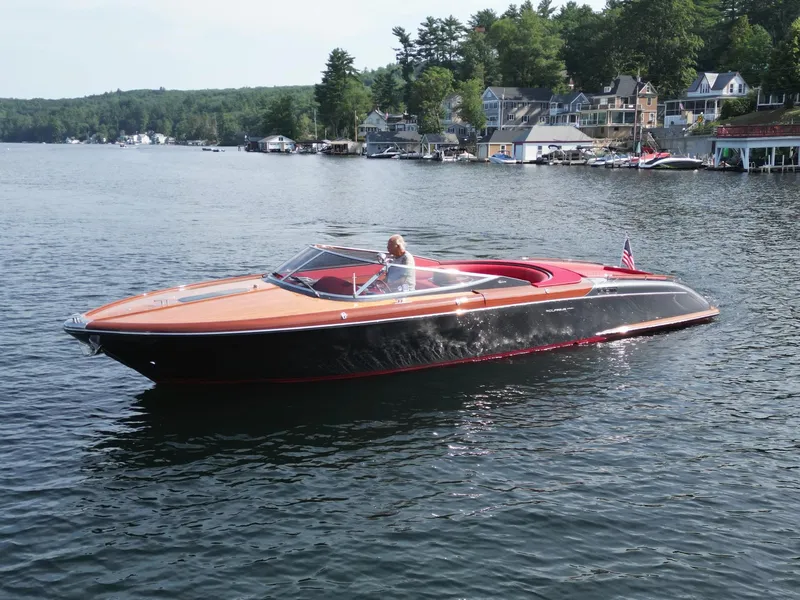 Slide: The Image of 2013 Riva Aquariva 33 luxury boat cruising on a scenic lake. - 16