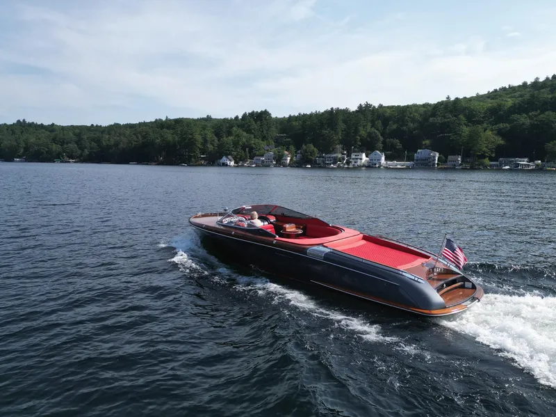 Slide: The Image of 2013 Riva Aquariva 33 cruising on a scenic lake with lush green shoreline. - 17