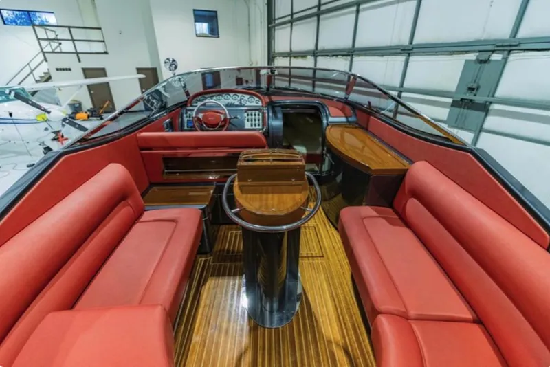 Slide: The Image of Luxurious 2013 Riva Aquariva 33 interior with red seating and polished wood accents. - 20