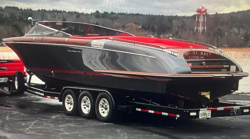 Slide: The Image of 2013 Riva Aquariva 33 boat on a trailer, parked outdoors. - 21