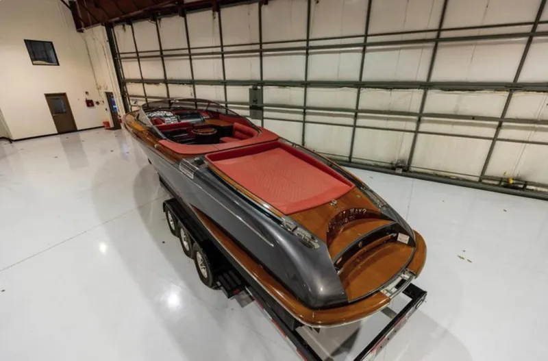 Slide: The Image of 2013 Riva Aquariva 33 luxury boat in a spacious indoor storage facility. - 24