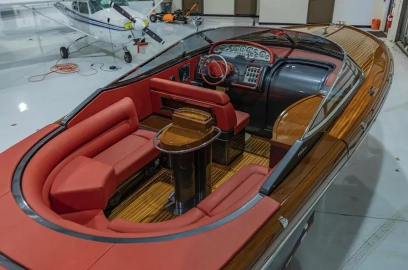 Slide: The Image of Luxurious 2013 Riva Aquariva 33 boat with elegant red seating and polished wood interior. - 26