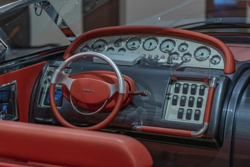 Slide: The Image of Dashboard of a 2013 Riva Aquariva 33 with red leather accents and classic gauges. - 27