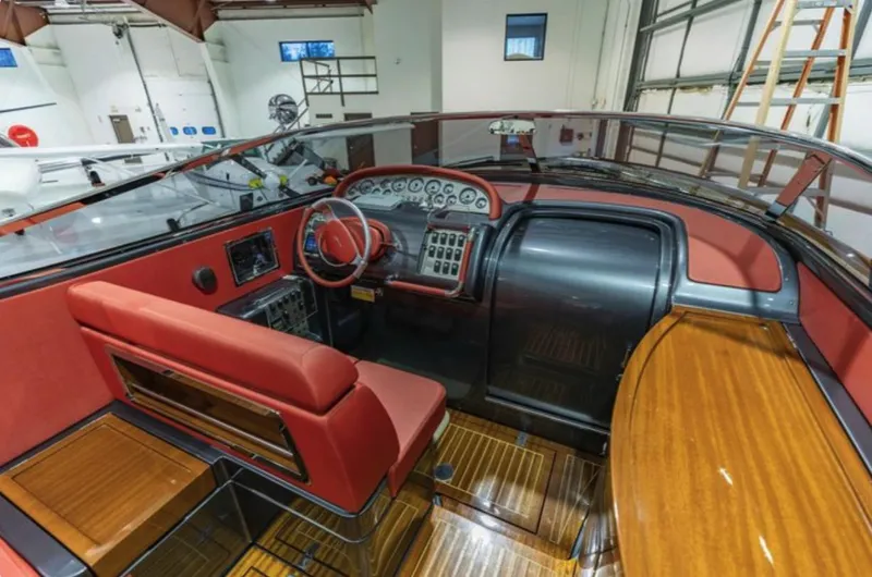 Slide: The Image of 2013 Riva Aquariva 33 boat interior with red seating and wooden accents. - 34