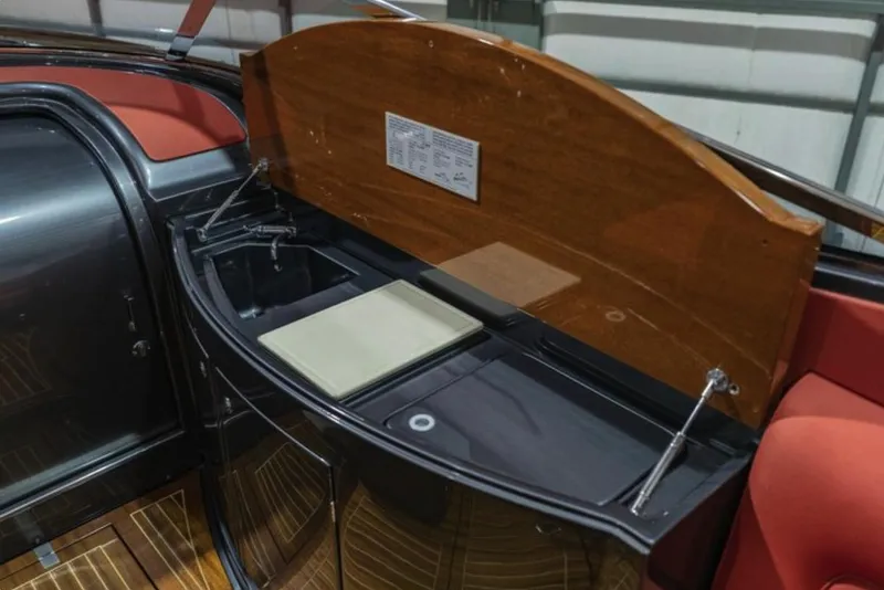 Slide: The Image of 2013 Riva Aquariva 33 interior with sleek kitchenette and wooden accents. - 39