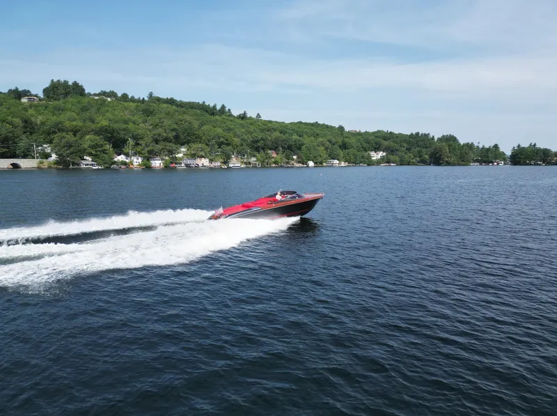Slide: The Image of 2013 Riva Aquariva 33 speedboat cruising on a scenic lake. - 44