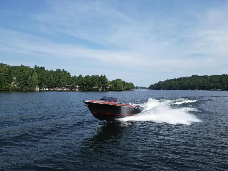 Slide: The Image of 2013 Riva Aquariva 33 speedboat cruising on a scenic lake. - 48