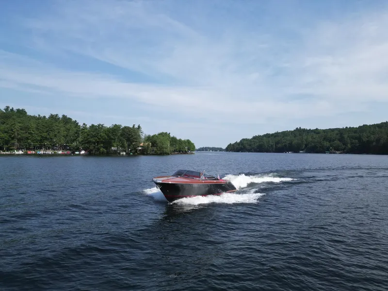 Slide: The Image of 2013 Riva Aquariva 33 cruising on a scenic lake under a clear blue sky. - 49