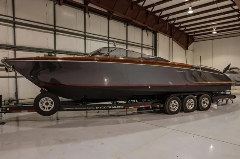 Slide: The Image of 2013 Riva Aquariva 33 boat on trailer in indoor storage facility. - 14