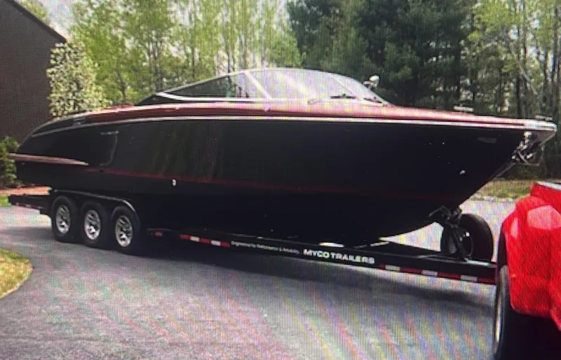 Slide: The Image of 2013 Riva Aquariva 33 boat on trailer, parked outdoors, surrounded by trees. - 18