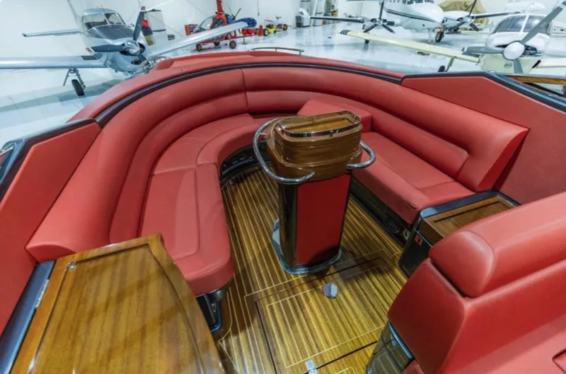 Slide: The Image of Luxurious 2013 Riva Aquariva 33 interior with red leather seating and wooden flooring. - 28