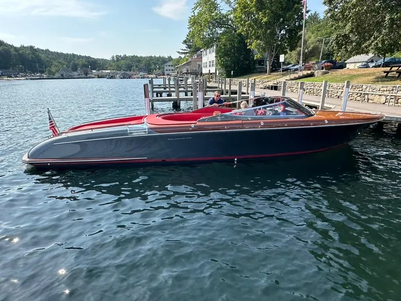 Slide: The Image of 2013 Riva Aquariva 33 luxury boat docked on a serene lake. - 7