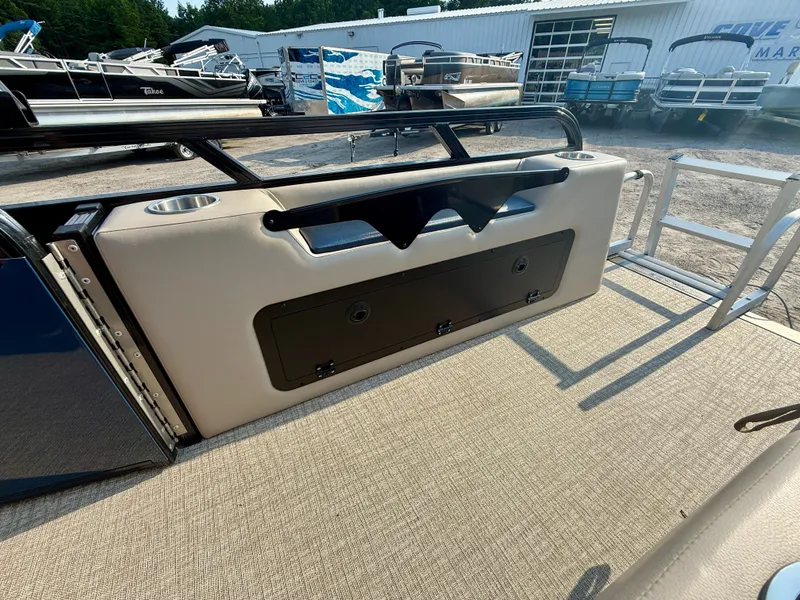 Slide: The Image of 2025 Tahoe Pontoon Sport 85 Versatile Rear Bench with storage and cup holders, docked outdoors. - 12