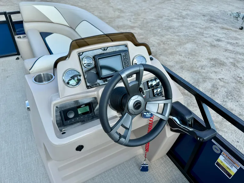 Slide: The Image of 2025 Tahoe Pontoon Sport 85 Versatile Rear Bench dashboard with steering wheel and controls. - 16